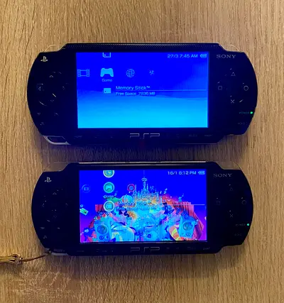 2 PSP consoles, 2000 Series + 1000 Series with charger + Memory cards.