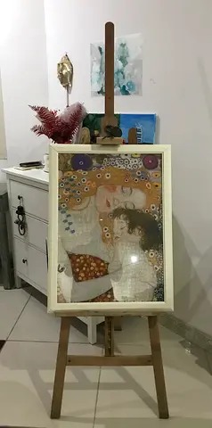 An easel and a painting by Gustav Klimt titled Motherhood. (Assembled from puzzle pieces)