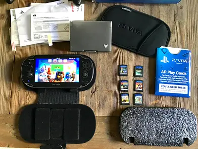 PS VITA 3G/WIFI OLED MODEL WITH 6 GAMES + POUCH + CHARGER + 8GB MEMORY CARD.