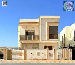 Luxury two-story villa for sale in Ajman, modern design and prime location, at an attractive price i