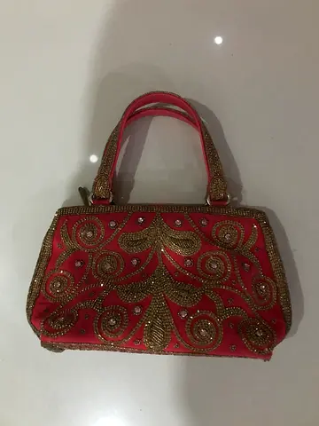 A collection of various womens bags, including a large gray tote bag, a short black bag, a gray Fur