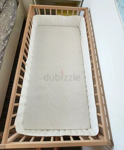 Wooden baby crib, quilted mattress, white padded bumper, baby car seat