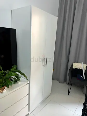 white two-door wardrobe with melamine finish and metal handles