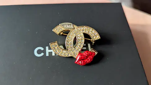 Chanel Brooch with Sparkling Stones and Red Lip Design
