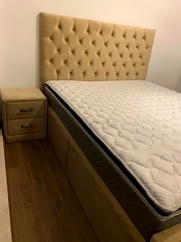 Elegant Bed with Plush Headboard and Nightstand