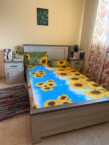 Bed with mattress and side table