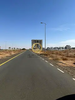 For sale: Residential land in Sharjah Al-Houshi, Al-Badea District, area of 10,000 sq ft, on an 18-m