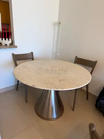 Elegant Round Dining Table with Stylish Base and dining chairs