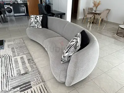Stylish Curved Grey Sofa with Cushions