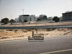 Commercial land for sale in Al Falah – Muweilah Commercial Area, featuring a prime location behind