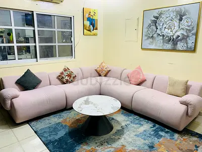 Stylish Pink Sectional Sofa with Marble Coffee Table