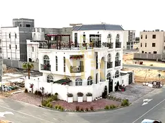 In Al Bahia, Ajman, a corner villa with two floors and a rooftop terrace, fully air-conditioned, fre