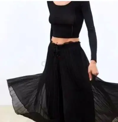 A beautiful womens black pleated midi skirt made of a lightweight fabric, such as dark emerald chif