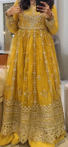 Stunning Yellow embellished panneled net dress with lrhanga and net duappata.