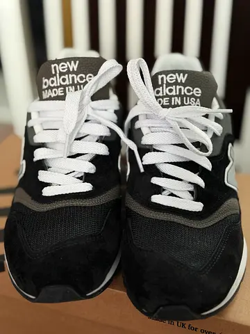 New Balance 997 Made in USA sneaker in a black and grey colorway, featuring a suede and mesh upper w