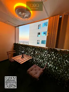 One-bedroom apartment for sale in Ajman Pearl Tower with parking and an open view of Ajman Creek.