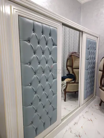 A big modren gray lether cabinet with mirror