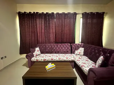 Elegant Purple Sofa Set with Floral Accent along with 4 curtains and double slit table