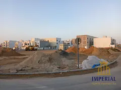 Residential investment land for villa, corner plot on two streets and an alley in Al Helio 2