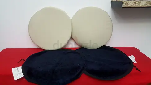 Round beige cushions with black covers