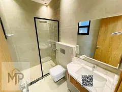 A luxurious two-story villa with a modern design, featuring six master bedrooms, an elegant majlis,
