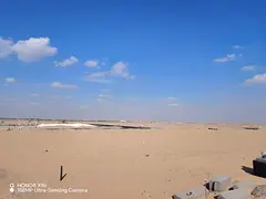 Corner residential plot for sale in Al Blida 1, second block from the mall.