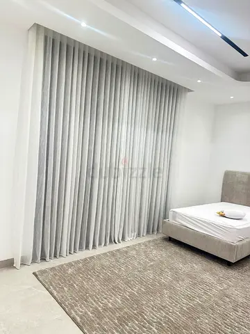 Elegant Modern Bedroom Décor with Curtains and Rug