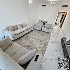 With an open view, a furnished 2-bedroom apartment with a living room for monthly rent in Ajman - Ra