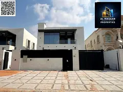 Luxury villa with a modern design, 5000 sq ft, with a garden, behind Ajman Academy. Price includes a