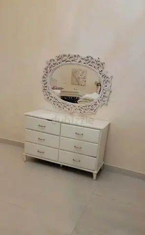 Elegant White Dresser with Intricate Mirror