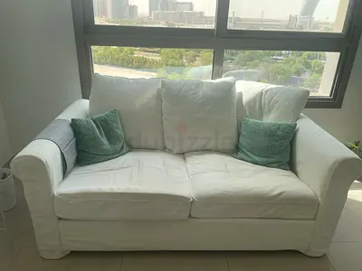 Stylish White Coffee Table with Storage Shelf and Sofa