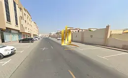 Land for sale in Sharjah, Muwaileh Commercial Area, near schools on an asphalt road.