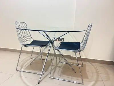 Modern Glass Dining Table with Stylish Wire Chairs