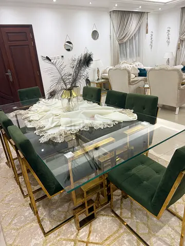 Elegant Glass Dining Table with Green Velvet Chairs