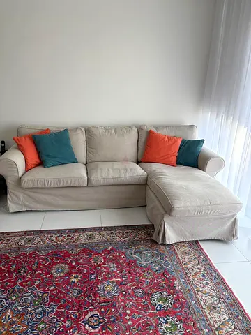 Cozy L-Shaped Sofa in Neutral Fabric with Colorful Cushions