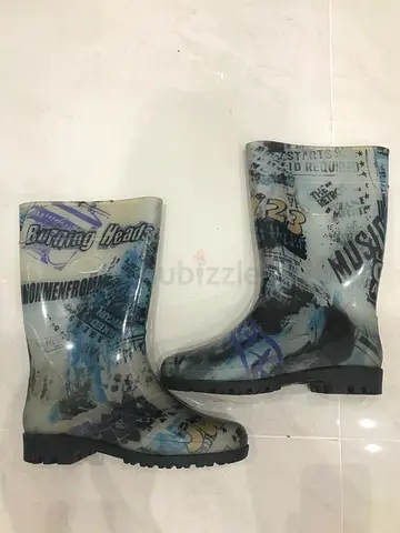 These rubber boots feature a unique print featuring newspaper clippings and graphics. Similar styles