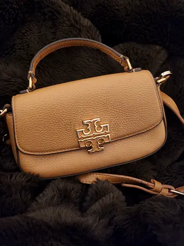 Tory burchThis is a Tory Burch Britten Mini Top Handle bag in tan leather.