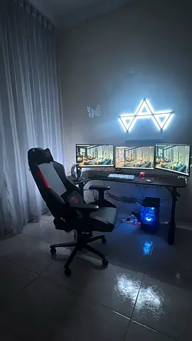Gaming Setup with Triple Monitors and Ergonomic Chair