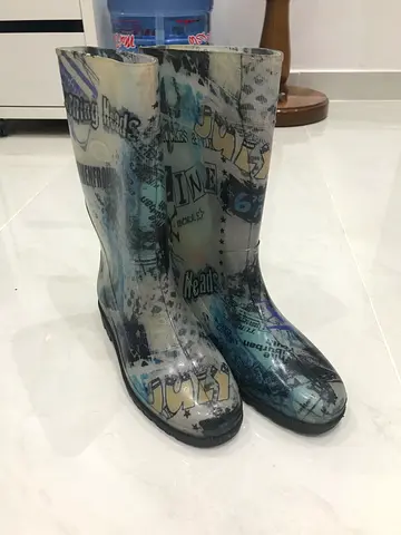 These rubber boots feature a unique print featuring newspaper clippings and graphics. Similar styles