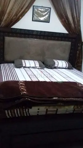 Comfortable King-Sized Bed with Elegant Headboard