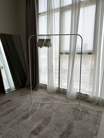 Clothes rail with wooden hangers