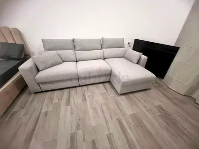 Light grey Ikea eskilstuna L shape sofa under storage
