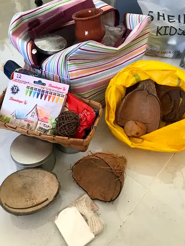 Materials that can be used for arts and crafts, including candles, coconut shells, and a set of cray