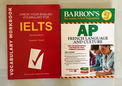 Two books designed for language exam preparation: one for IELTS and one for AP French Language and C