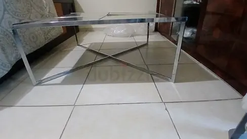Square mirrored coffee table with chrome X-base ​Modern glass top