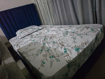 Stylish Blue Velvet Bed with Floral Bedding