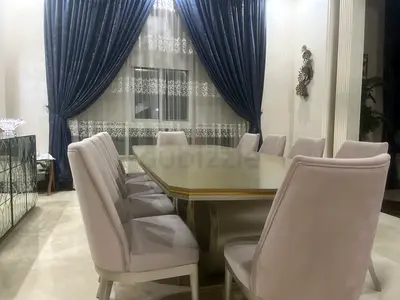 Elegant Dining Table with Plush Chairs