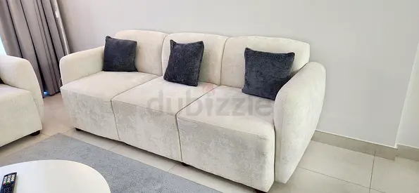 5-Seater Beige Sofa with Grey Cushions + Extra cushion covers.