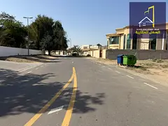 A residential corner plot on a main street and side lane in Al Quoz,