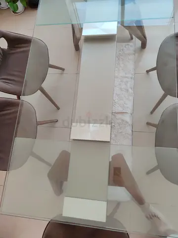 Stylish Glass Dining Table with Comfortable rotating Chairs